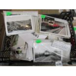 A box containing mixed black and white and colour photographs of locomotives