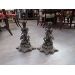 A pair of Black Forest candle sticks, the bases with hares and wolves,