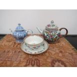 Two Chinese teapots and a Chinese tea bowl and saucer