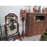 A pair of Oriental red lacquered lanterns on carved feet with animal finials,