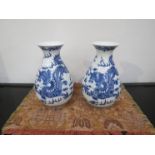 A pair of 20th Century Chinese blue and white vases with dragon detail, 22cm tall,