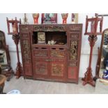 An early to mid 20th Century highly ornate carved lacquered and gilded Oriental cabinet with