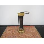 A brass miners lamp with rounded base,