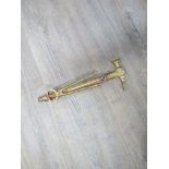 A brass hammer and pincers design wall hanging thermometer