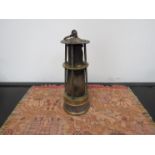 A brass and steel miners lamp with tall conical glass and short gauze