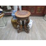 An early 20th Century Oriental marble top stand with dragon supports,