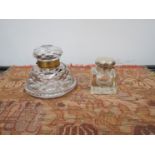 A Victorian cut glass desk inkwell and silver topped inkwell,