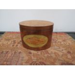 A 19th Century yew wood veneered oval tea caddy with inlaid shell design