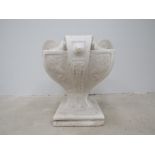 An Art Nouveau plaster urn with scroll embellishment,