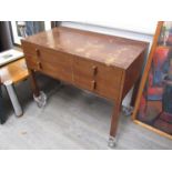 An early to mid 20th Century teak two drawer dressing table/desk (water damaged).