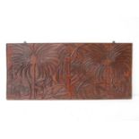 An early 20th Century Papua New Guinea carved fruitwood panel depicting coconut harvesters with
