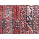 Two 20th Century Persian rugs and a Caucasus rug all worn, varying sizes,