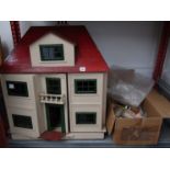 An Early to Mid 20th century dolls house with red roof,