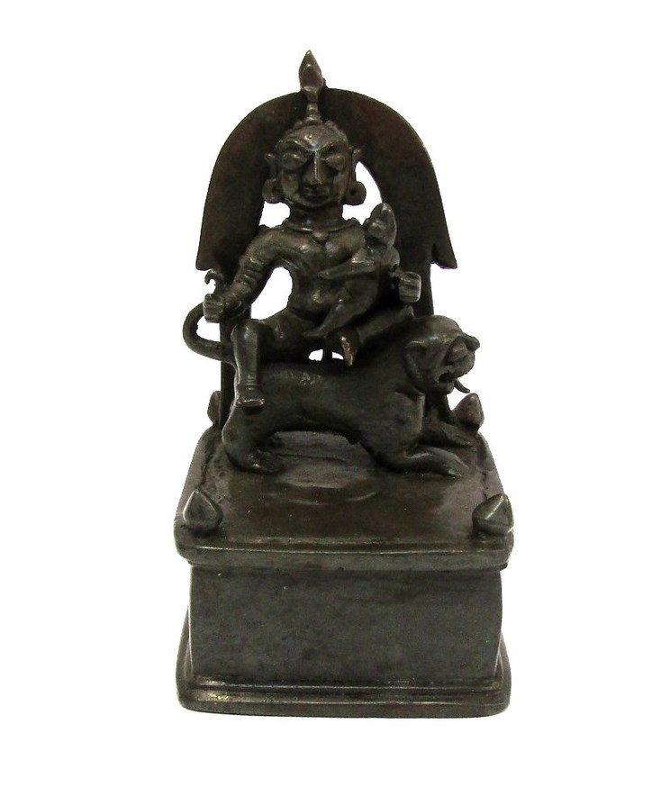 An 18th/19th Century Indian altar bronze as a deity seated on a lion,