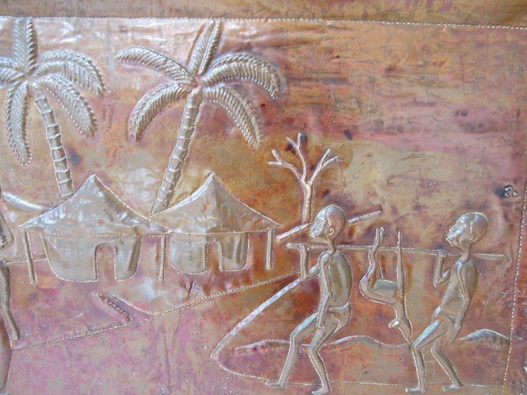 A hammered copper plaque depicting African hunters returning to village. - Image 2 of 3