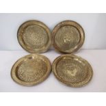 Seven late 19th Century embossed brass chargers of varying designs, diameter approx. 45.