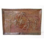 A hammered copper plaque depicting African hunters returning to village.