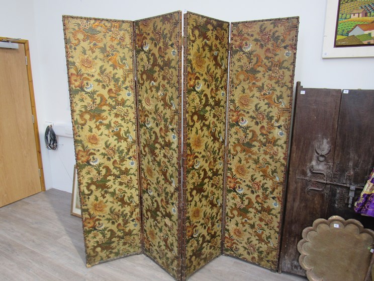 A 19th Century four fold screen/room divider with embossed floral panels, leather and stud edging,