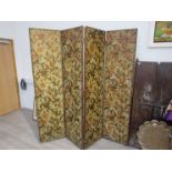 A 19th Century four fold screen/room divider with embossed floral panels, leather and stud edging,