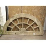 A 19th Century carved stone arch window 50cm tall x 99cm long