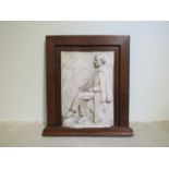 MISS AMY DIMELOW (Active 1906-1944): A high relief plaster panel depicting a seated gentleman in
