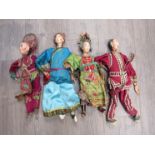 Circa 1900 four Oriental dolls/puppets with handpainted faces,