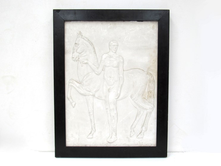 A 20th Century moulded plaster relief panel of a Greek standing beside a horse, 66.