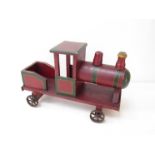 An early Edwardian wooden toy train with red painted box metal cast wheels.