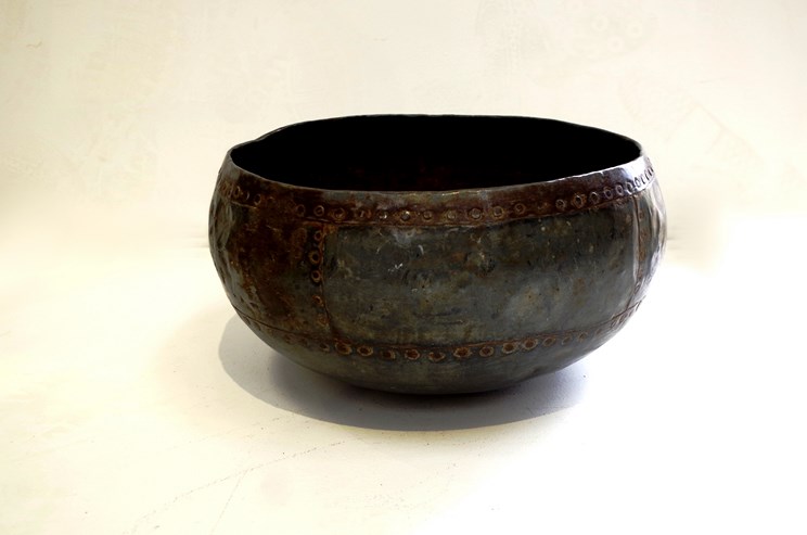 A late 19th Century Eastern hammered metal bowl of rivetted construction, - Image 2 of 2