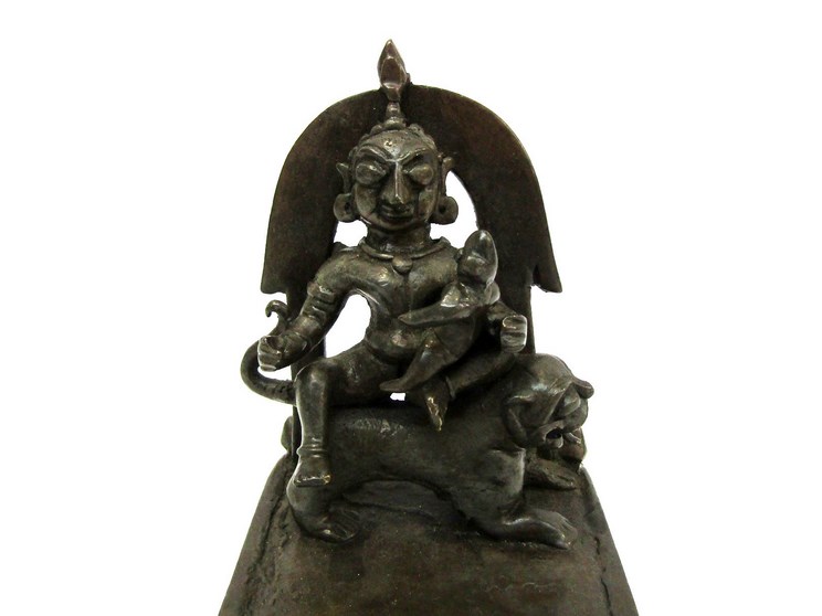 An 18th/19th Century Indian altar bronze as a deity seated on a lion, - Image 2 of 2