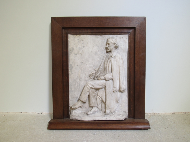 MISS AMY DIMELOW (Active 1906-1944): A high relief plaster panel depicting a seated gentleman in