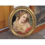 A pair of 19th Century oils on oval glass panels of young maidens,