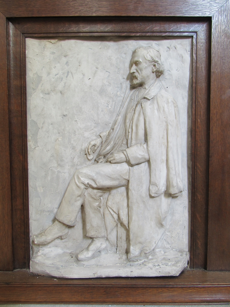 MISS AMY DIMELOW (Active 1906-1944): A high relief plaster panel depicting a seated gentleman in - Image 2 of 2