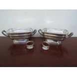 A pair of William Bennett silver sauce tureens, gadrooned edging and reeded handles,