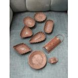 A selection of tinware moulds,