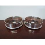 A pair of John Bull Ltd modern silver wine coasters with turned wood bases, London,