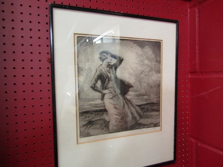 After Percy Lancester, an engraving of a lady standing in a landscape, framed and glazed,