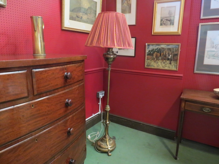 A brass standard lamp partially converted from an oil lamp,