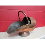 A Victorian copper helmet coal scuttle