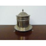 A William Hutton & Sons silver cylindrical wafer/biscuit box on three footed base, Sheffield 1902,