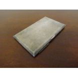 A white metal cigarette case with engine turned inner and outer stamped sterling silver,