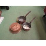 Three copper graduated pans and a copper pan with embossed image of stags