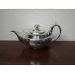 A Georgian silver teapot, with engraved swag detail acanthus thumb grip, London 1786,