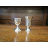 A silver egg cup, Chester 1912, and Russian silver vodka cup dated 1892,