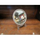 A Samuel Jacob silver hand mirror with hinged handle converting to a free standing mirror with