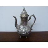 A Victorian silver coffee pot of melon form with high relief floral embellishment.