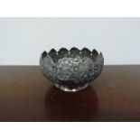 An Indian white metal footed bowl with engraved and embossed jungle scene with animals