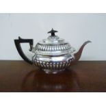 A George III silver gadrooned teapot, London 1808, ebony knop and hanfle,