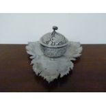 A white metal leaf and berry dish with central lidded pot,