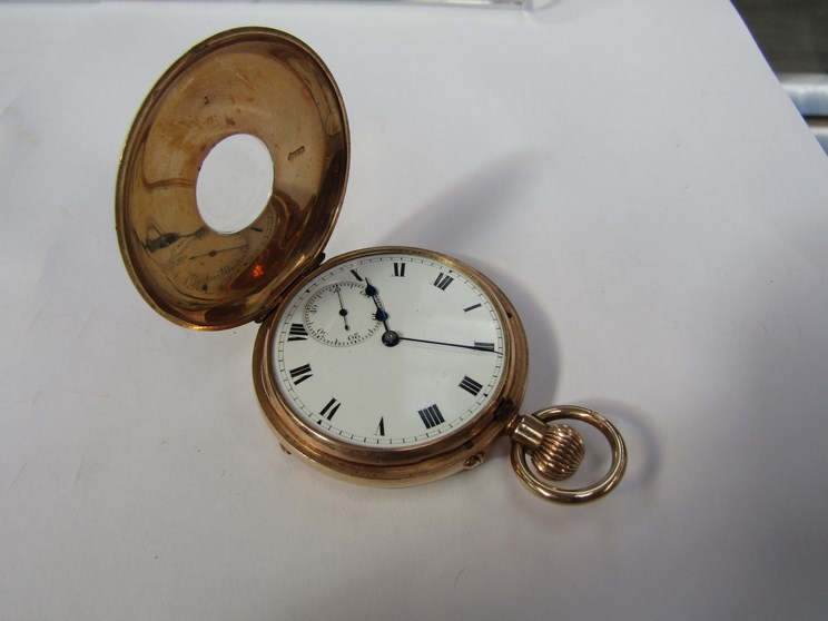 A 9ct gold half hunter pocket watch with Roman enamelled dial, subsidiary seconds,